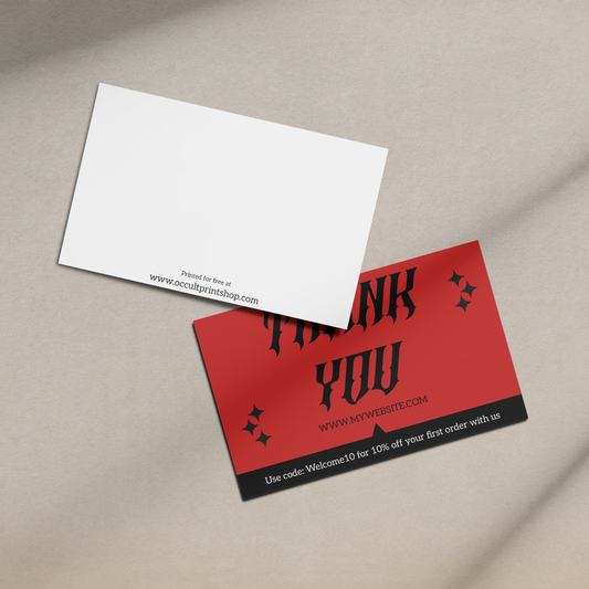 Red and black business card with 'Thank You' text on a beige surface.