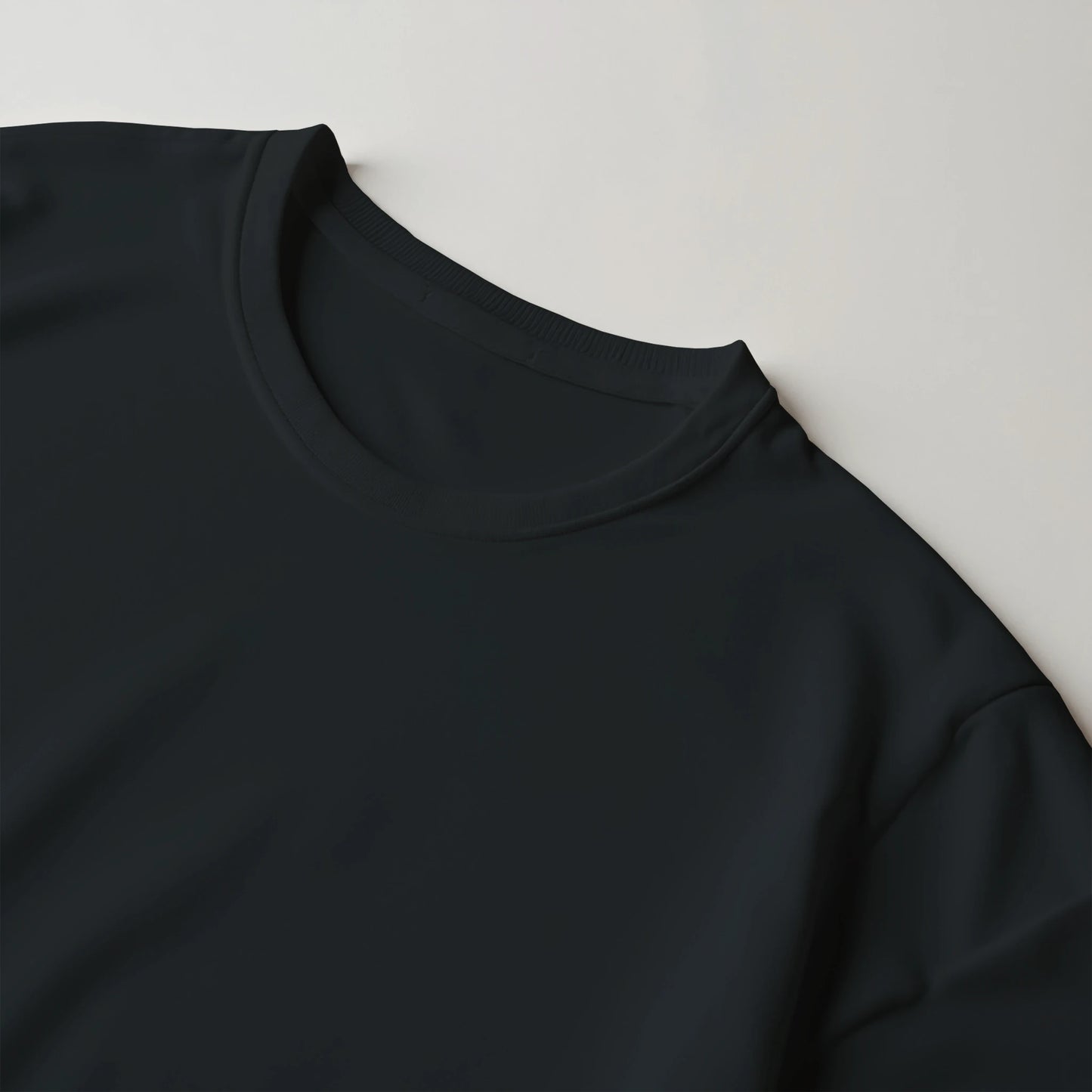 Close-up of a black sweatshirt sleeve on a light gray background