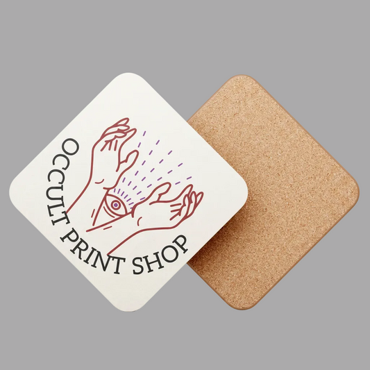 Two square coasters on a plain gray background. One coaster is white with a red line drawing of hands and an eye, with the text 'Occult Print Shop' printed around it.