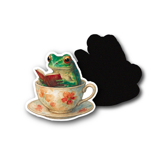 A CUTE WATER COLOURED HAND DRAWN FROG IN A TEARCUP READING A BOOK, CUSTOM PRINTED DIE CUT MAGNETS PERFECT GIFT OR FRIDGE AND NOTICE BOARDS. PRINTED AT OCCULT PRINT SHOP, CHEAP HIGH QUALITY. 