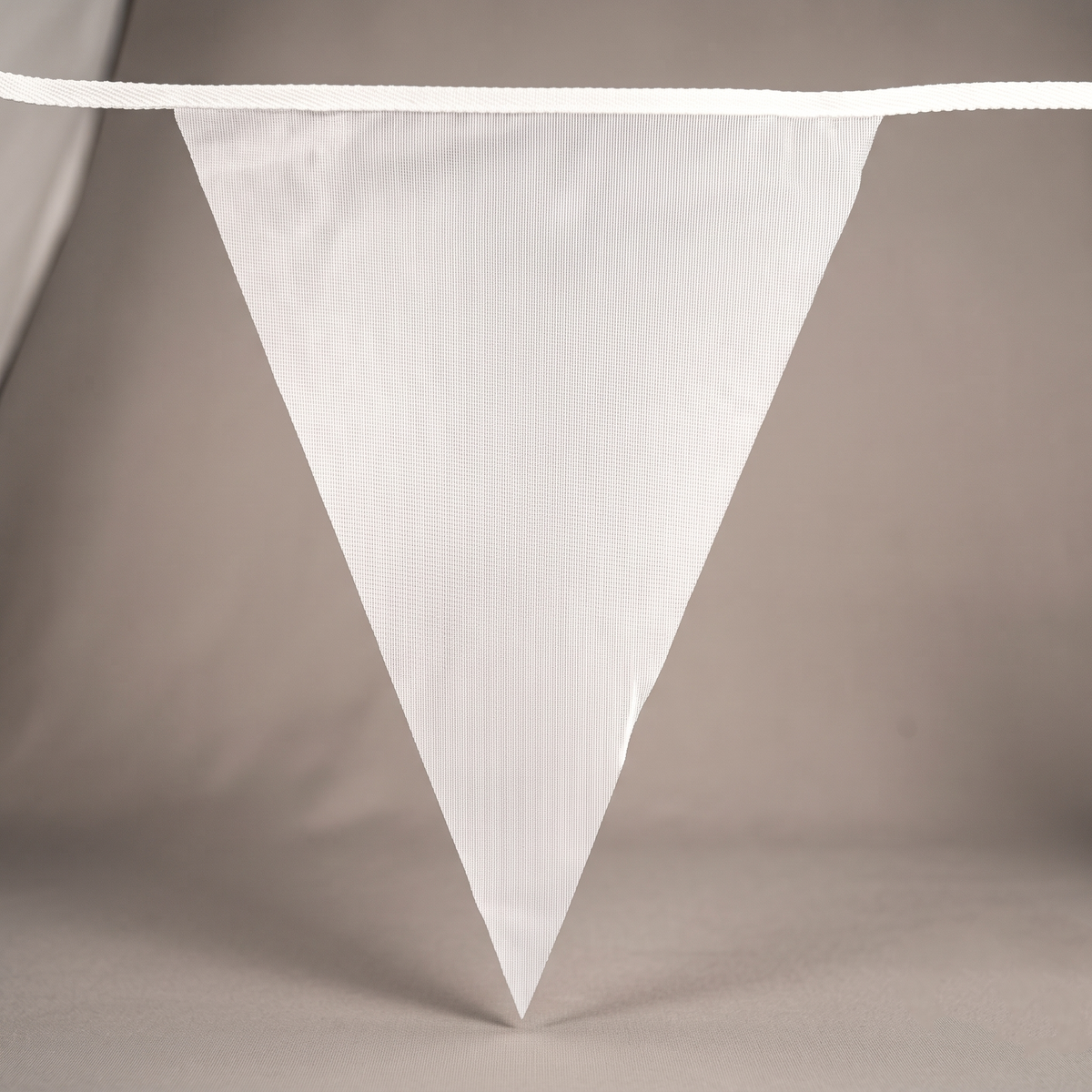 Close-up of a blank white triangular bunting pennant ready for custom printing.