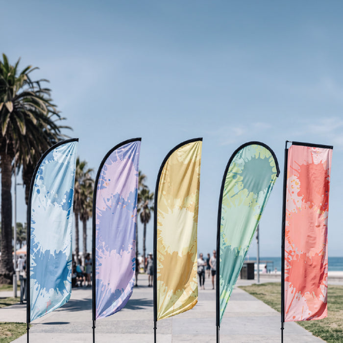 Custom Full Fibre flags displayed outdoors with printed promotional graphics.