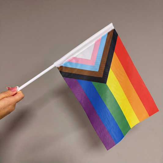 Custom hand waving flag with rainbow pride artwork on a white handheld pole.