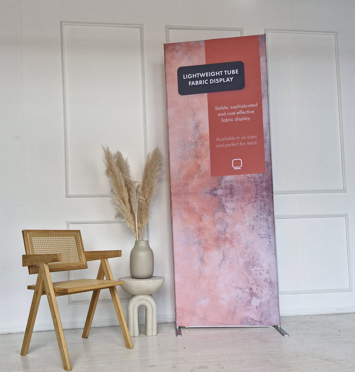 Lightweight tube display with stretch fabric graphic in an interior setting