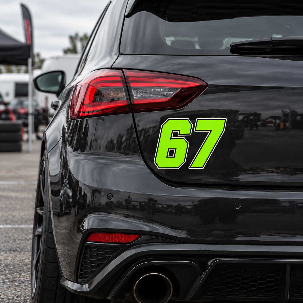 Bright lime racing number 67 die-cut stickers shown on the rear panel of a black sporty car