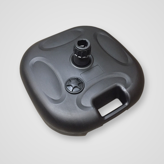 A black plastic outdoor furniture base or pedestal with a central mounting post, a circular star-patterned detail, and a recessed handle cutout, shown on a light gray background.