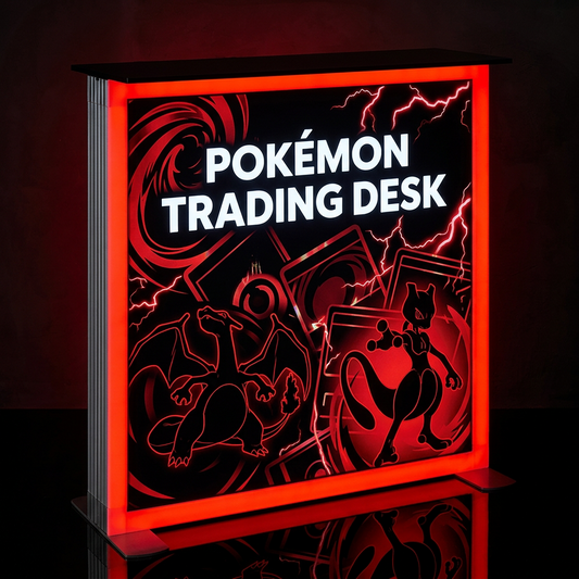A Pokémon-themed trading desk lamp or sign with a glowing red-orange border and black interior featuring the words 'POKÉMON TRADING DESK' and illustrated Pokémon characters, shown on a dark reflective surface.