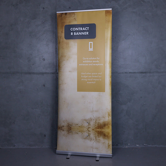 Professional roller banner displayed with a printed graphic against a grey wall